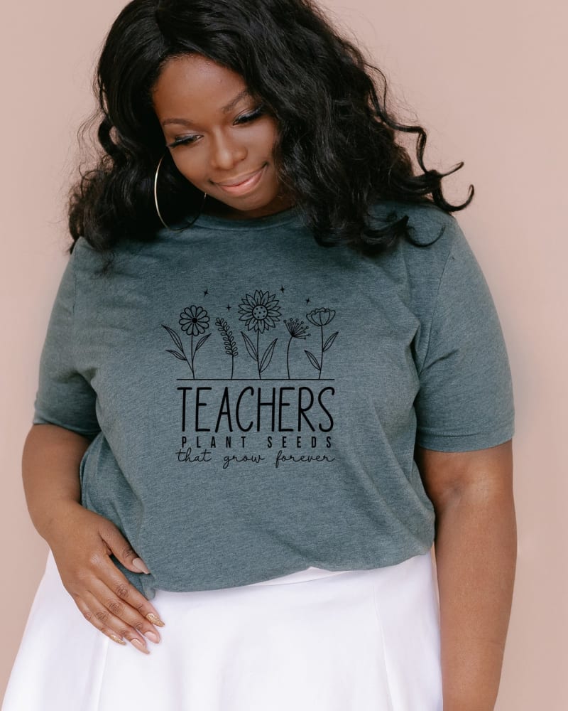 Front of a model wearing a size Large Teachers Plant Seeds That Grow Forever in Forest by Simply Sage Market. | dia_product_style_image_id:281590